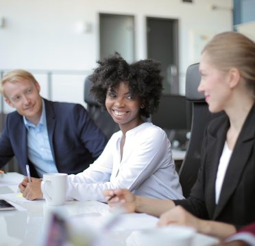 A view of businesspeople sitting around a table while happily chatting